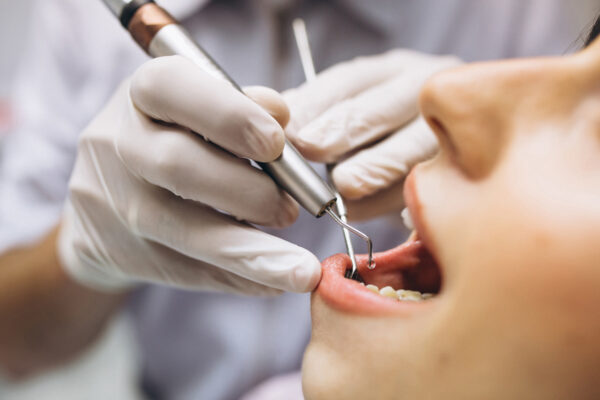 Woman patient at dentist Importanța Controlului Hemostatic în Stomatologie: Tehnici și Soluții pentru un Câmp Operator Optim